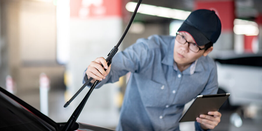 Young Asian Auto Mechanic Holding Digital Tablet Checking Windsh