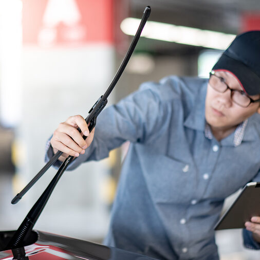 Young Asian Auto Mechanic Holding Digital Tablet Checking Windsh